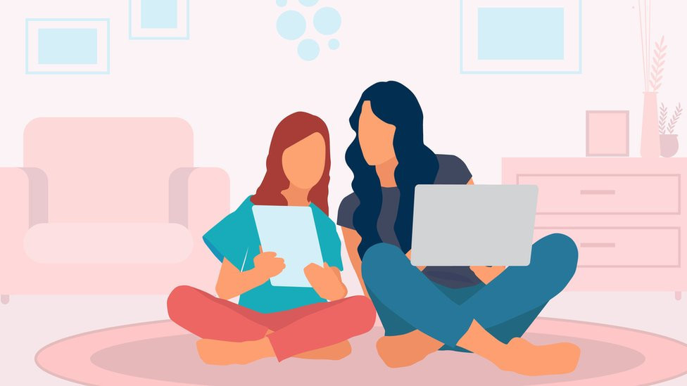 Mother and daughter sharing information on their laptops