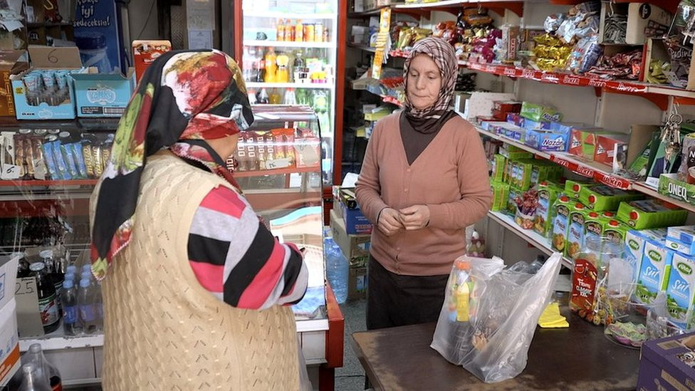 A shopkeeper in Istanbul speaks with a customer