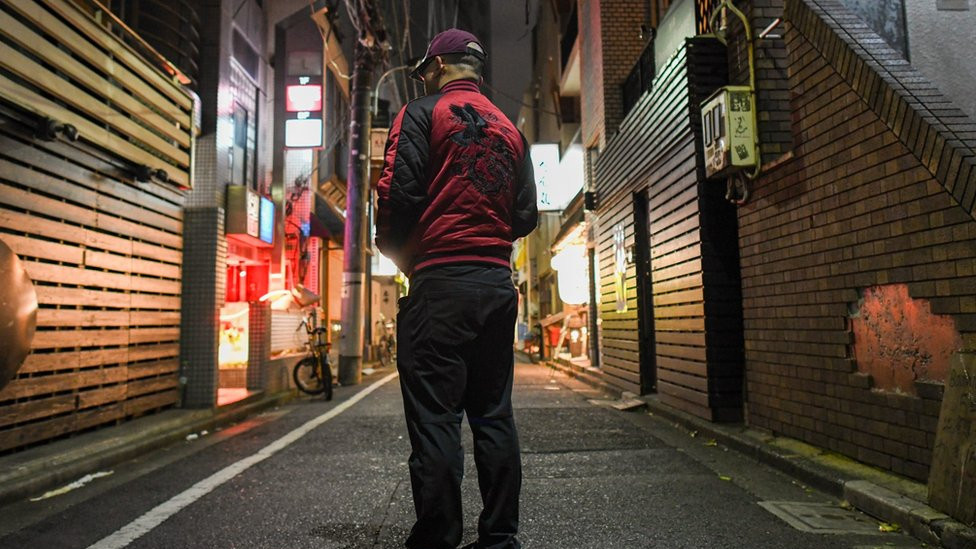 Image of the BBC's undercover reporter, photographed from behind on a Tokyo street