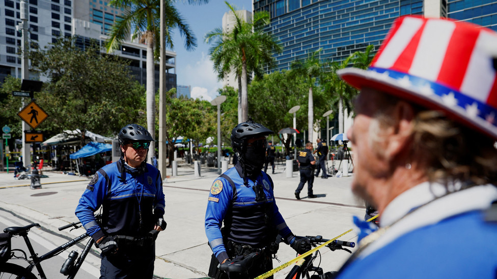 Police officers stand in a street cordoned with tape, after an unattended package was discovered on it, near the Wilkie D. Ferguson Jr. United States Courthouse, on the day former U.S. President Donald Trump is to appear at on classified document charges, in Miami, Florida