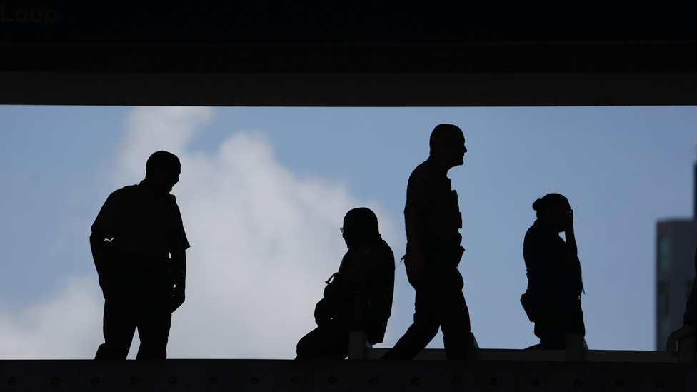 Law enforcement officials stand guard at a transit stop outside of the Wilkie D. Ferguson Jr. federal courthouse on June 13, 2023 in Miami, Florida
