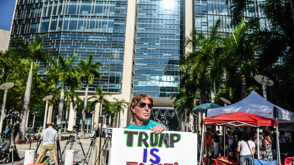 A protester against former U.S. President Donald Trump holds a sign outside the Wilkie D. Ferguson Jr. United States Federal Courthouse where Trump is scheduled to be arraigned later in the day on June 13, 2023 in Miami, Florida