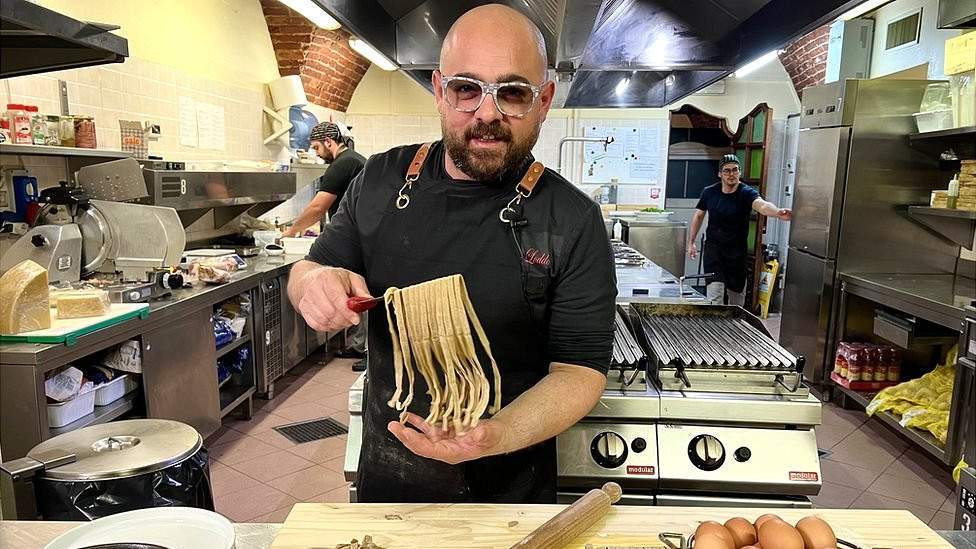 A chef at a restaurant in Italy makes pasta using flour made from crickets