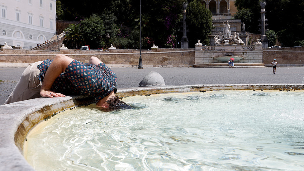 A person cools off at the Piazza del Popolo in Rome, Italy, on 18 July 2023