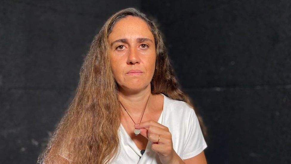 Tracey Najjar holding her pendant