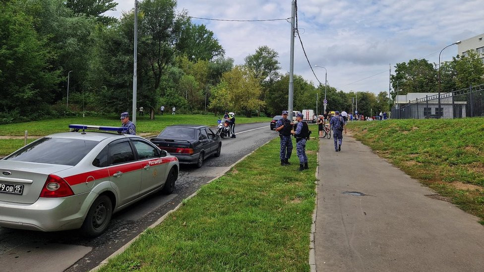 Russian law enforcement officers stand guard near the accident scene following a reported Ukrainian drone crash in Moscow, Russia, August 11, 2023. REUTERS/Stringer