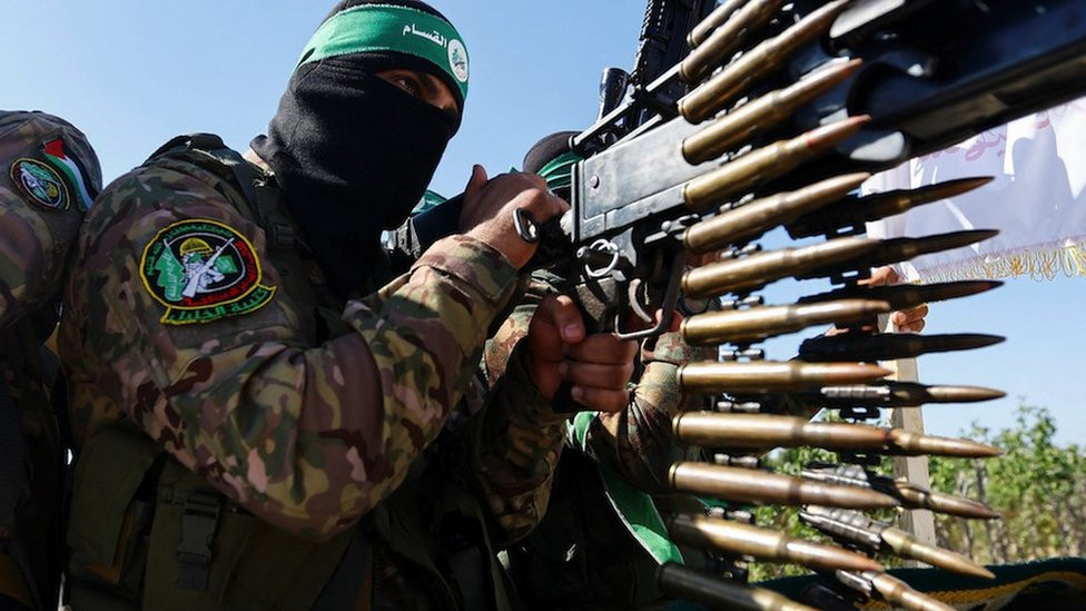 Palestinian fighters from the armed wing of Hamas take part in a military parade to mark the anniversary of the 2014 war with Israel in the Gaza Strip on 19 July 2023