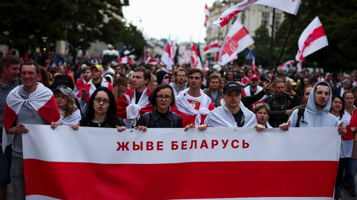 People carrying historical white-red-white flags of Belarus take part in Belarusians' march through Warsaw, on the third anniversary of the 2020 presidential election which was followed by mass protests over alleged electoral fraud, in Warsaw, Poland, August 9, 2023.