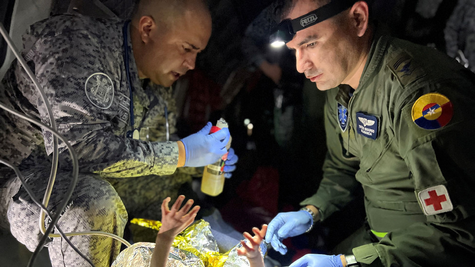 Members of the Colombian Air Force give medical attention inside a plane to the surviving children of a Cessna 206 plane crash in the thick jungle, while they are transferred to Bogota by air in San Jose del Guaviare, Colombia, June 9, 2023.