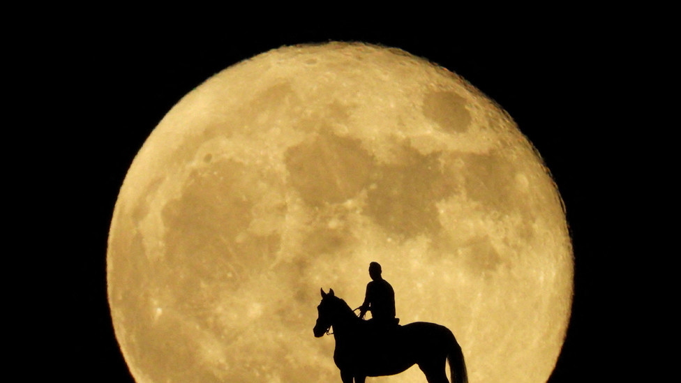 Jonay Ravelo and his horse Nivaria observe the super moon known as the Blue Moon, from a mountain in Mogan, in the south of the island of Gran Canaria, Spain, August 31, 2023.