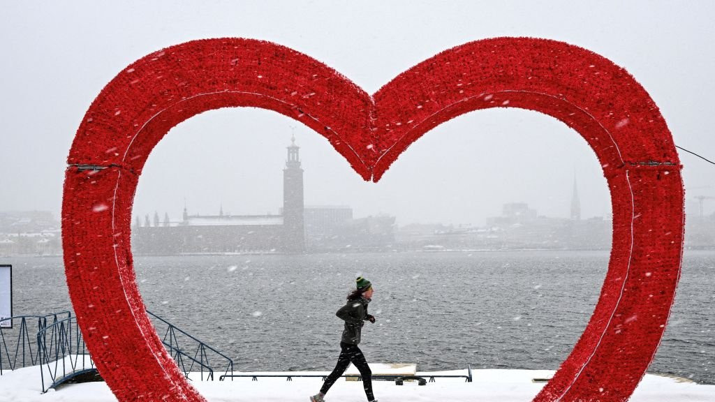 A runner jogs past Stockholm City Hall, Sweden, on 2 January.