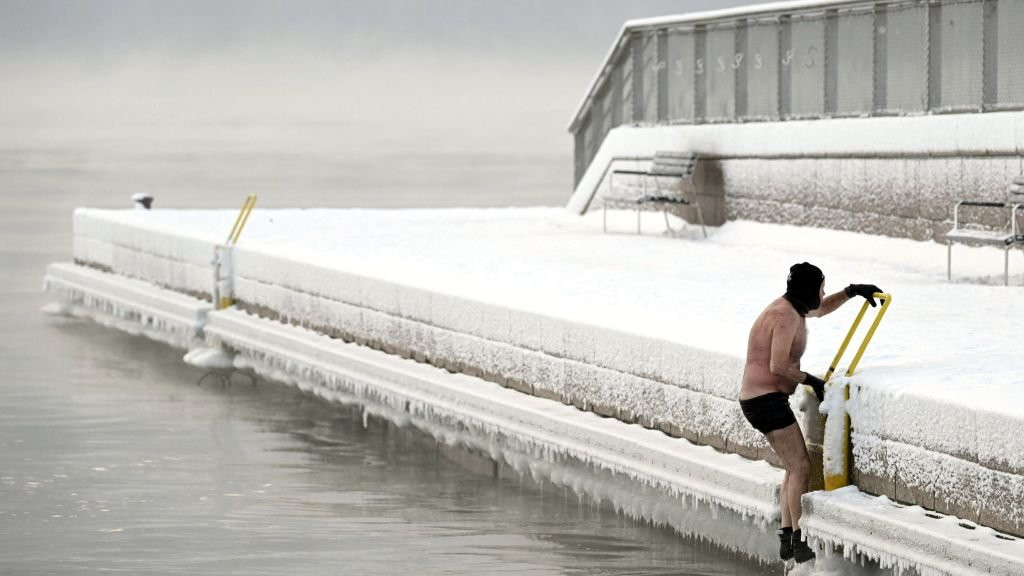 A man gets out from a swim in Helsinki, Finland, in weather of -15C.