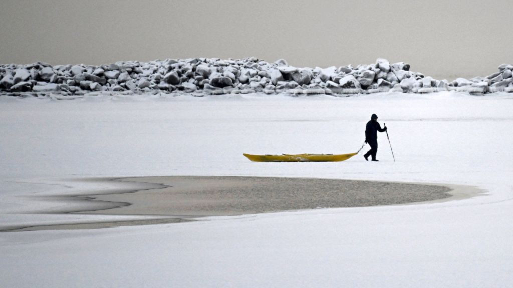 A man walks on the frozen sea in Helsinki, Finland.