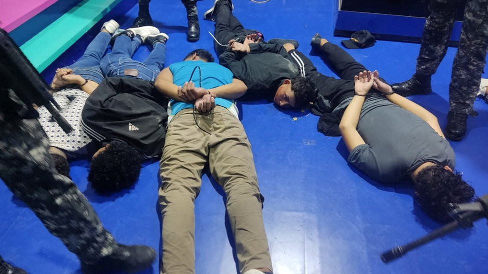 People accused of invading and taking over television station TC with weapons and forcing staff to lie and sit down, lie handcuffed on the floor in a police handout, in Guayaquil, Ecuador, January 9, 2024