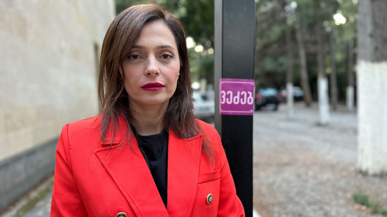 Tamuna Museridze in red jacket standing in the site of a hospital