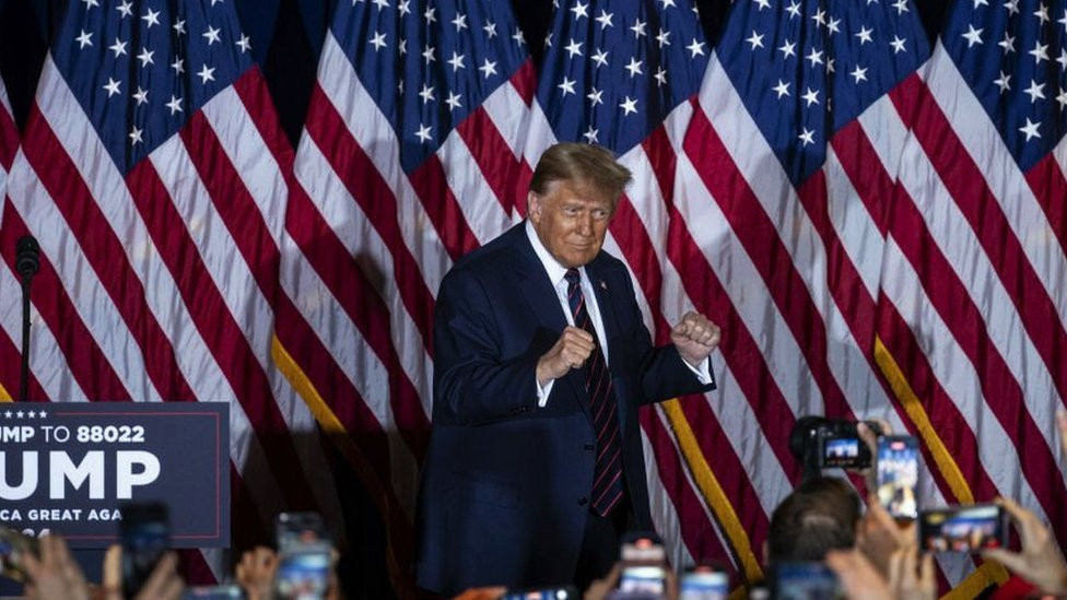 Former US President Donald Trump celebrates on stage during his primary night rally at the Sheraton on 23 January, 2024 in Nashua, New Hampshire