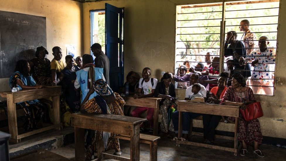 Voters wait to vote outside a voting station in Kinshasa, Democratic Republic of Congo