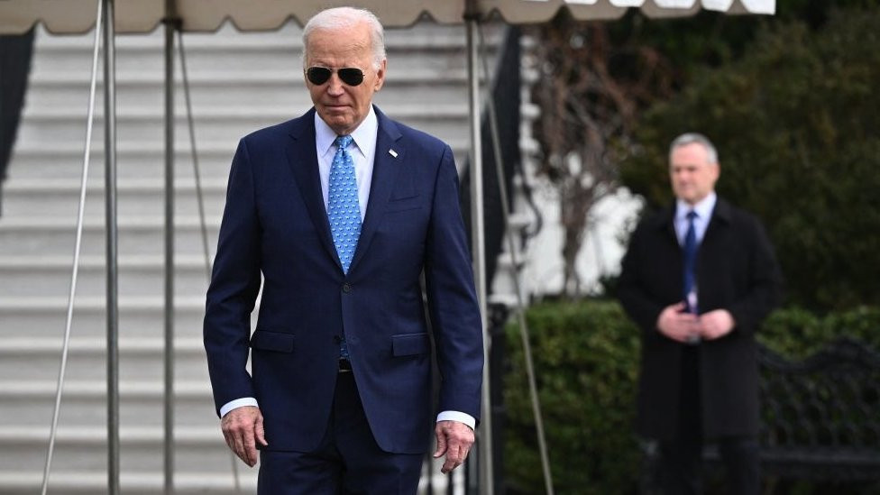 US President Joe Biden walks to talk to reporters before boarding Marine One on the South Lawn of the White House in Washington, DC, on 30 January, 2024