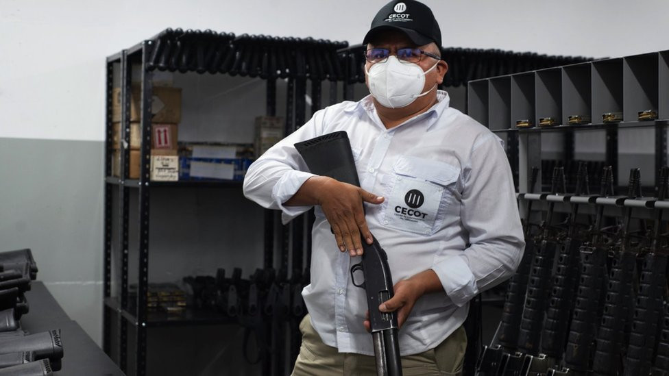 The director of Cecot, holding a shotgun and wearing a mask