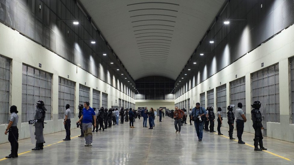 Journalists and prison guards inside Cecot