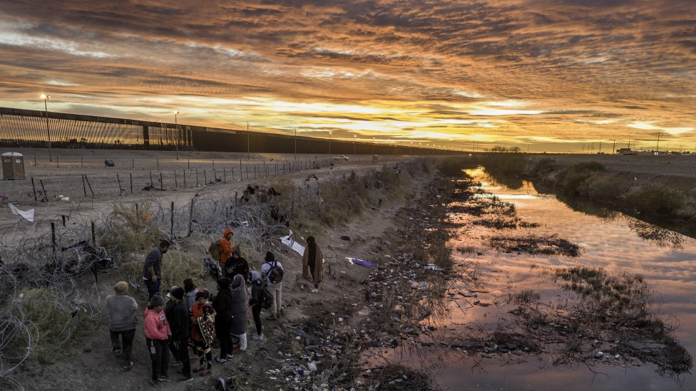 Migrants cross the Rio Grande