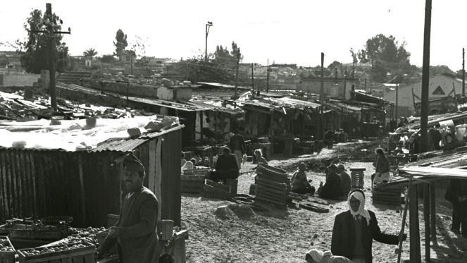 Palestinian refugees shop in the old market in Rafah in 1975