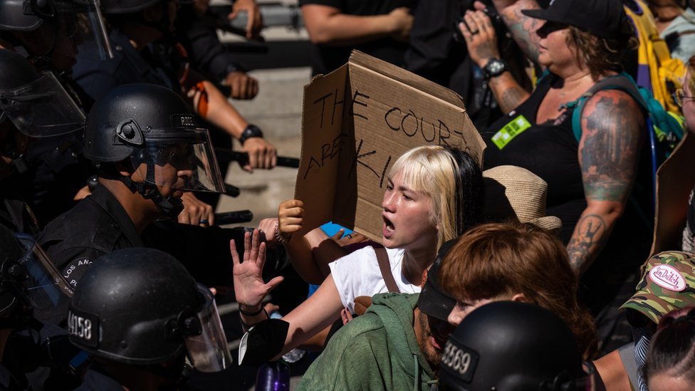 Police try to hold back protesters