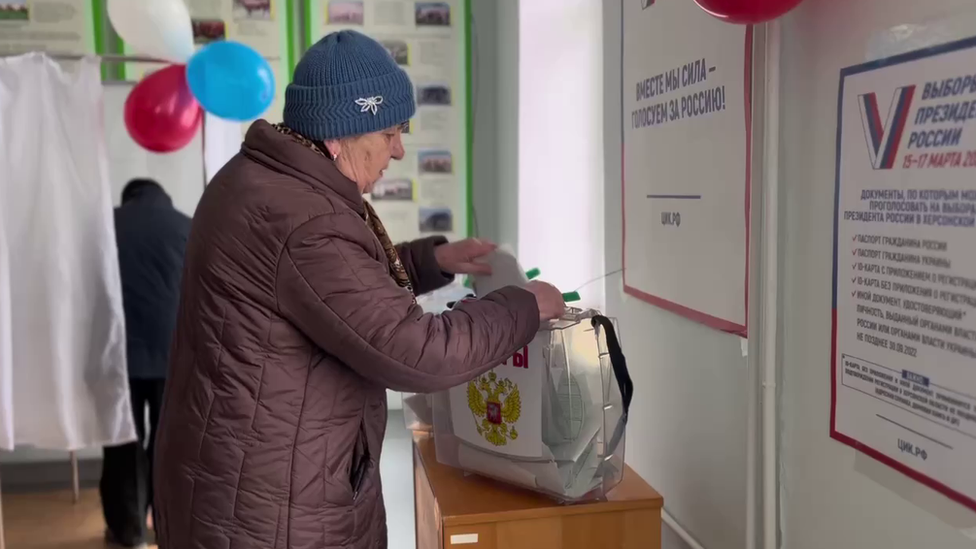 A woman votes in occupied Kherson