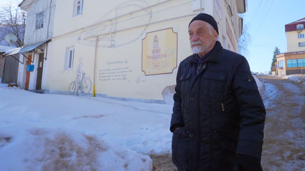 Vladimir Ovchinnikov walks near his graffiti