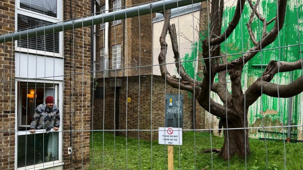 Carlos Serrano near to the Banksy mural in London's Finsbury Park