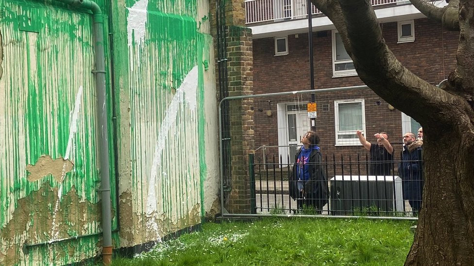 White paint across a section of the mural