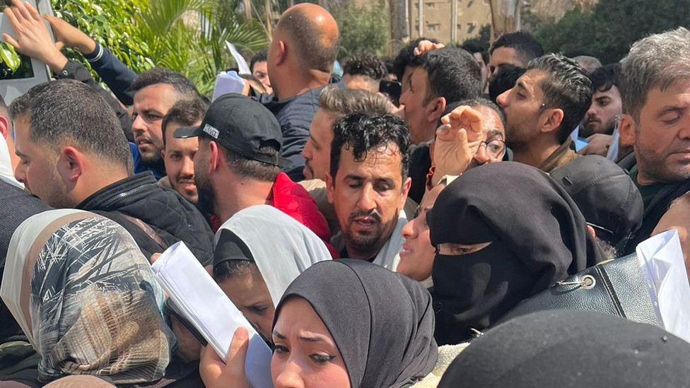 People crowd outside Hala offices in Cairo