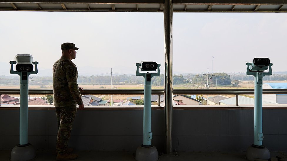 Commander Mercado looking out over the village from the townhall