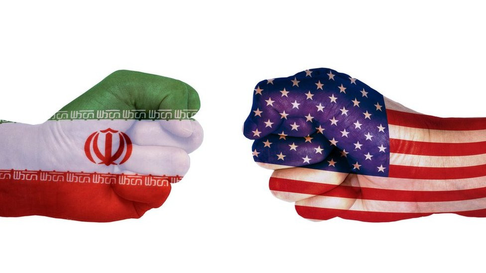 Fists in the colours of the US and Iran flags facing each other