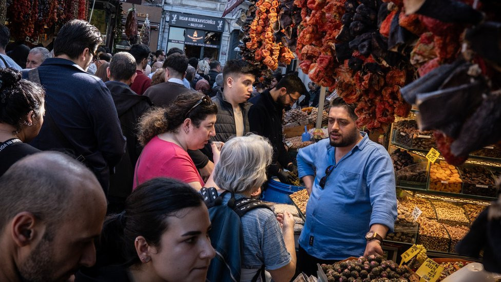 People shop in a busy market street in the Eminonu district ahead of the local elections on March 29, 2024 in Istanbul, Turkey.