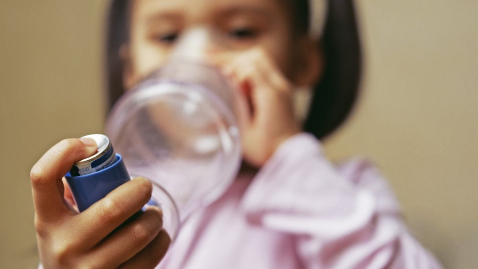 Girl using an inhaler