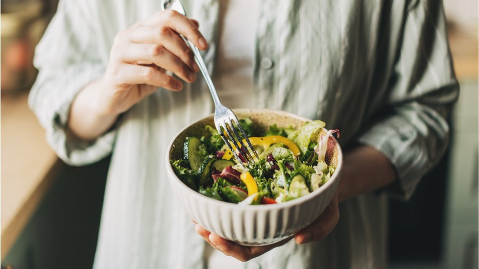 a person eating salad