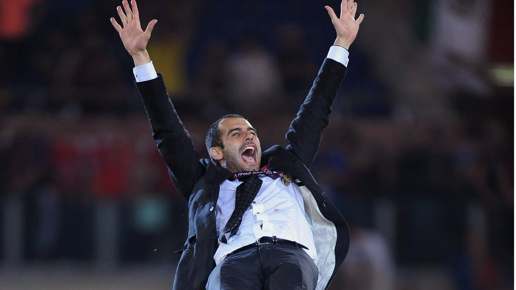 Pep Guardiola's is thrown aloft in celebration by his Barcelona players while Lionel Messi looks on