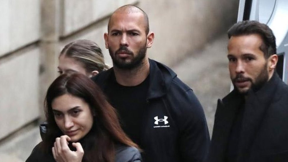 Andrew Tate, his brother Tristan, and an unidentified woman outside court on Tuesday