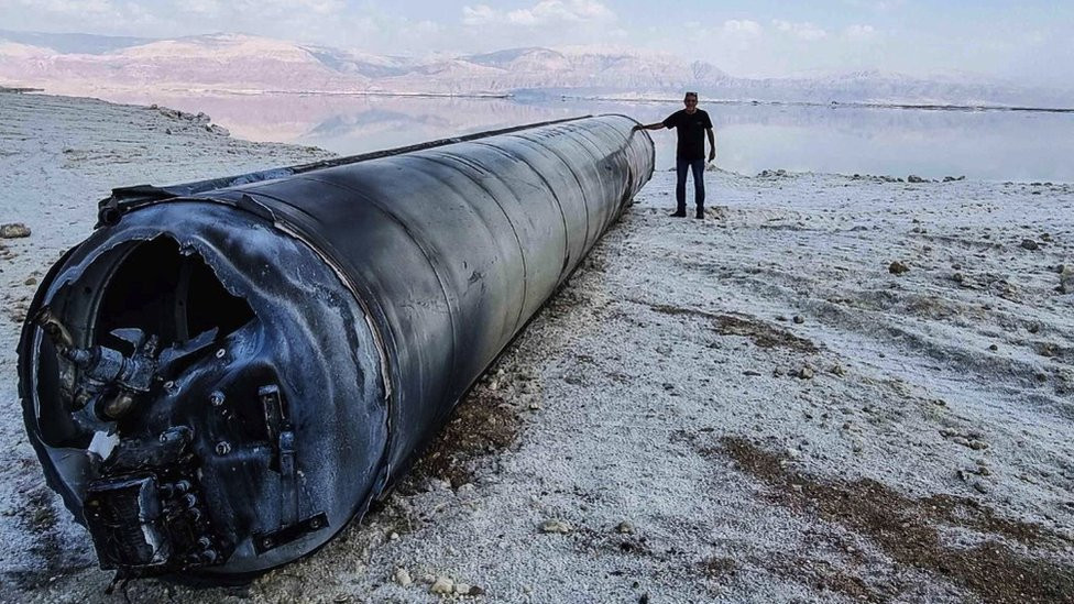 A ballistic missile with a man standing next to it - the missile is almost as wide as him