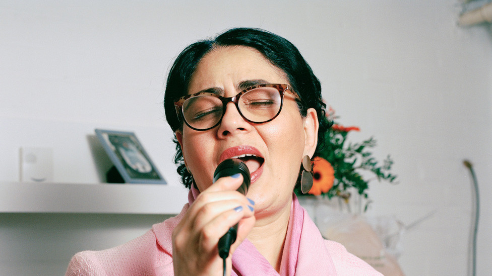 A woman singing into a microphone