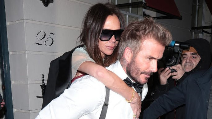 David Beckham carrying Victoria out of the party