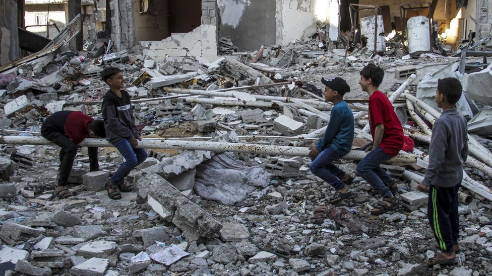 Children play on a seesaw they made themselves from the ruins at Jabalia refugee camp on 10 April, 2024.