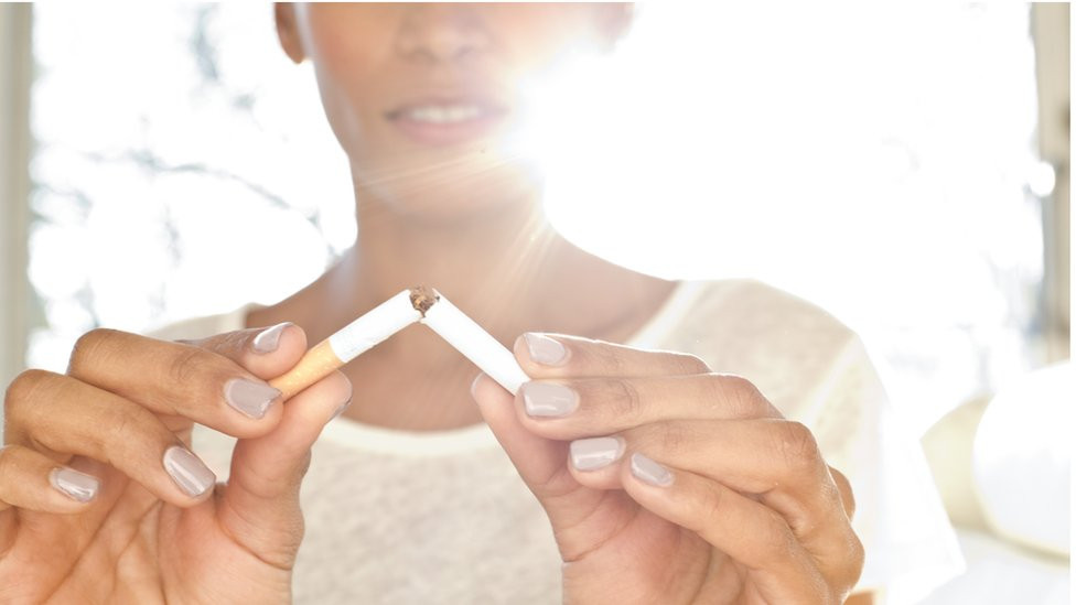 Woman snaps cigarette in two