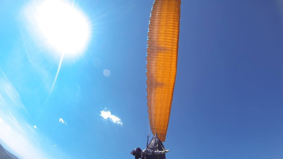 Osoba na žutom paraglajderu u vazduhu