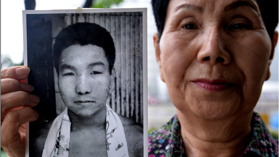 Hideko Hakamada, sister of former boxer Iwao Hakamada who has been on death row in Japan for 47 years, shows a picture of her young brother Iwao during an interview outside the Tokyo Detention House in Tokyo on May 20, 2013.