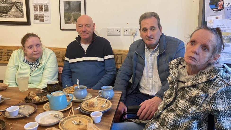 Two women and two men sat around a table