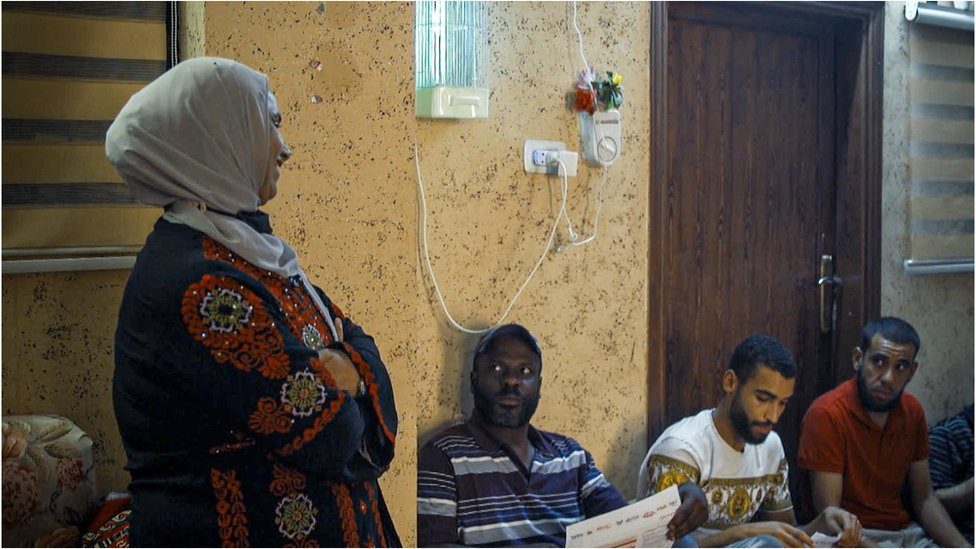 Dr Mahmoud smiling at a group of the men gathered for her session