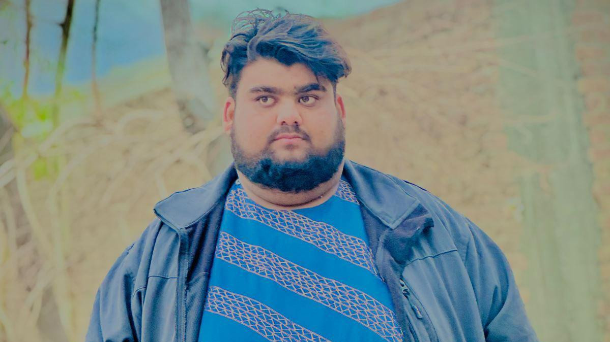 Qudratullah  seen in a blue jacket 