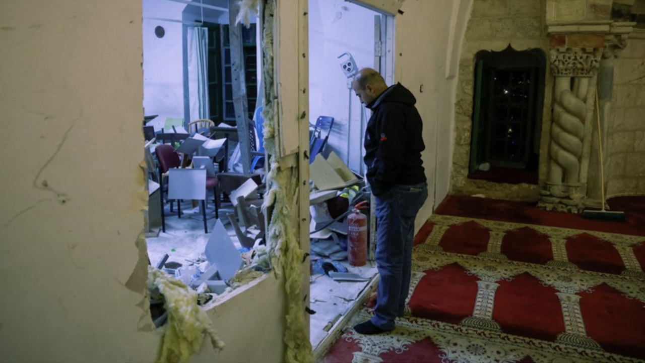 Muškarac u tamnoj dukserici i farmerkama, u čarapama, posmatra štetu unutar džamije Al Aksa, nakon sukoba između izraelske policije i palestinskih vernika, u istočnom Jerusalimu, 5. aprila 2023.